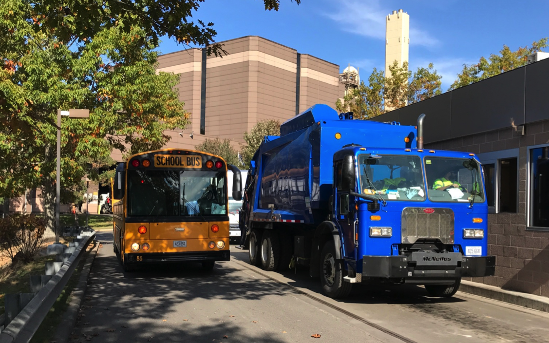 Trash truck and school bus