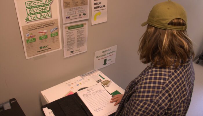 Sarah Folan displaying new programming at Piper Shores for the Multi-Family Recycling Initiative