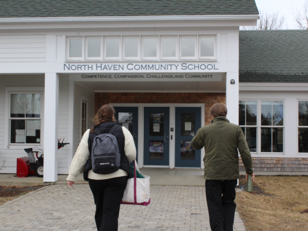 Bea Johnson, educator at ecomaine & Shaun Johnson, Principal at North Haven Community School walk side by side towards the front door of the schoolBea Johnson, educator at ecomaine & Shaun Johnson, Principal at North Haven Community School walk side by side towards the front door of the school